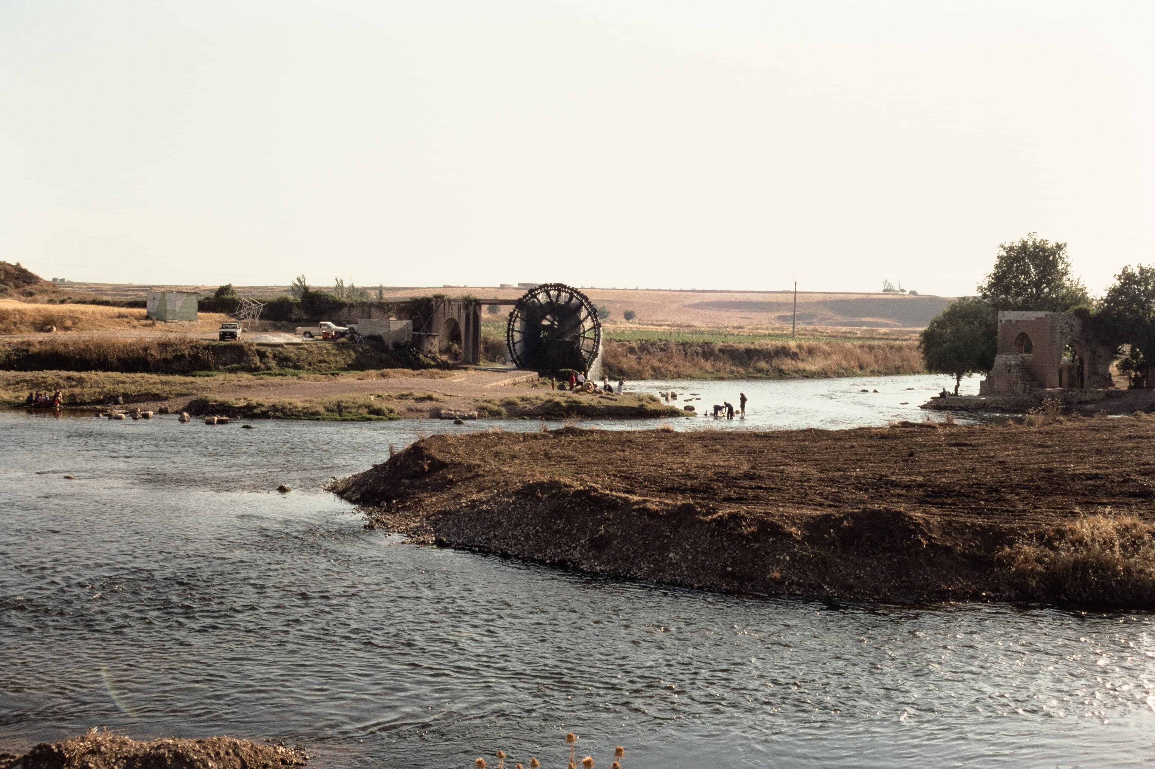 The Orontes River at Shaizar, Syria, with a historic noria (water wheel) on the far bank